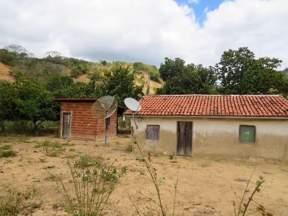 an old house with a satellite dish on the roof