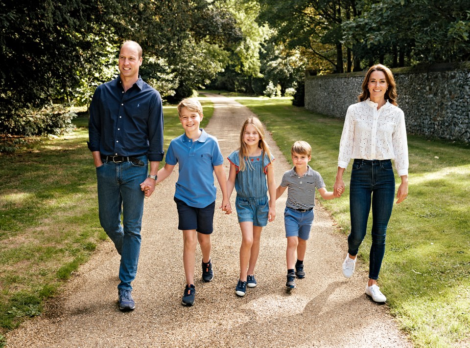 a family walking down a gravel road holding hands