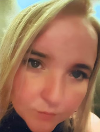 a close up of a woman 's face with a serious look on her face .