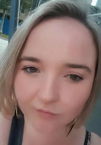a close up of a woman 's face with a serious look on her face .