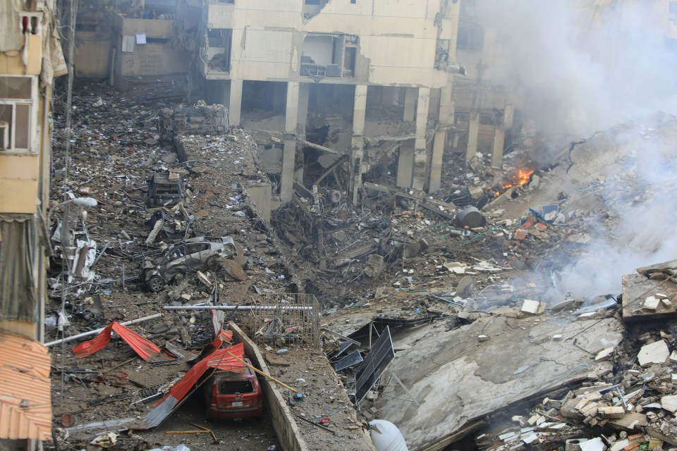 a red truck is parked in the middle of a pile of rubble