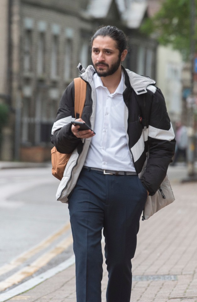 a man walking down the street looking at his phone