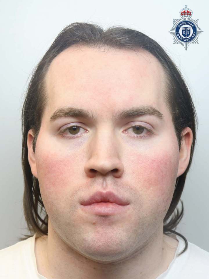 a man with long hair is wearing a white shirt and has a police badge on his head