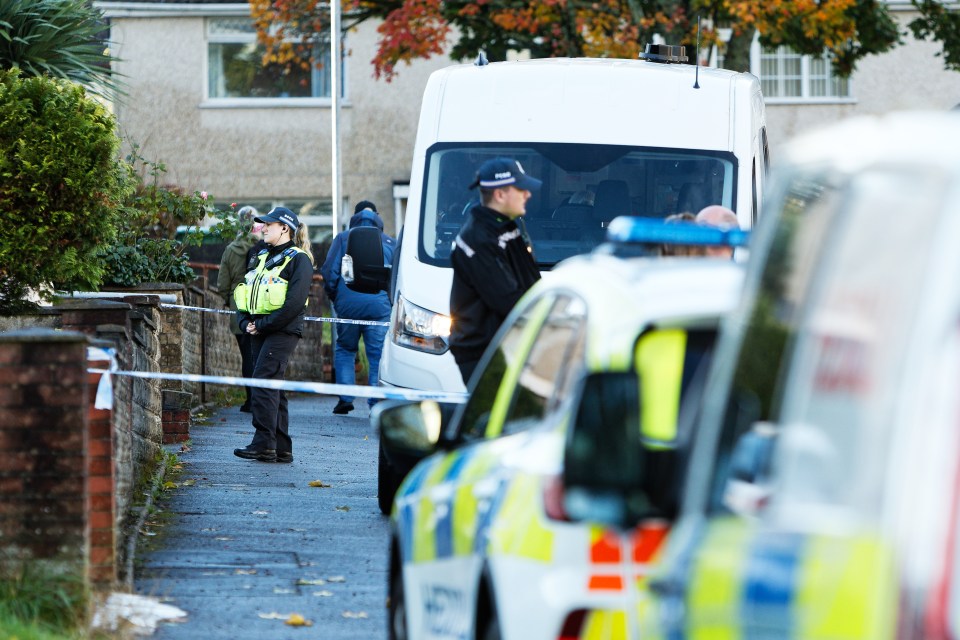 a group of police officers standing in front of a white van