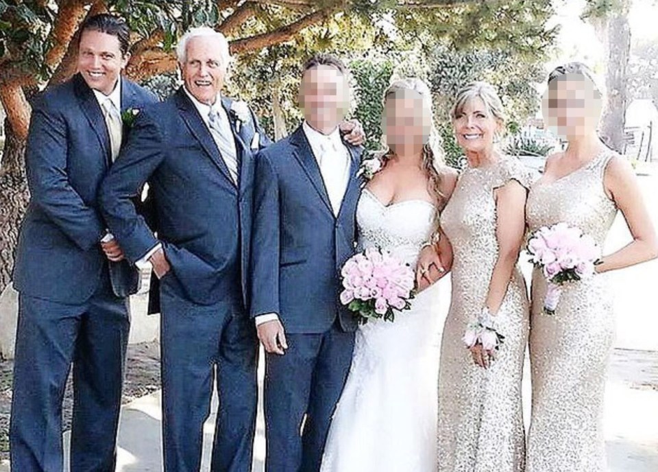 the bride and groom are posing for a picture with their wedding party .