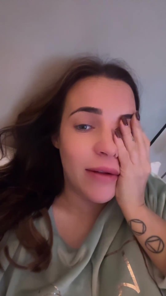 a woman with a tattoo on her wrist is covering her face with her hand
