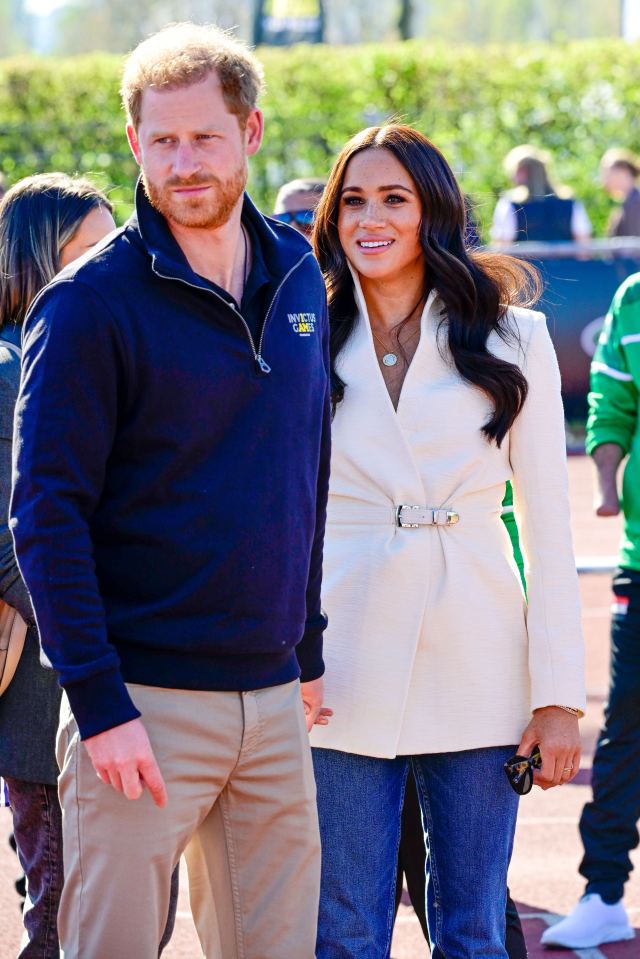 prince harry and meghan markle are standing next to each other