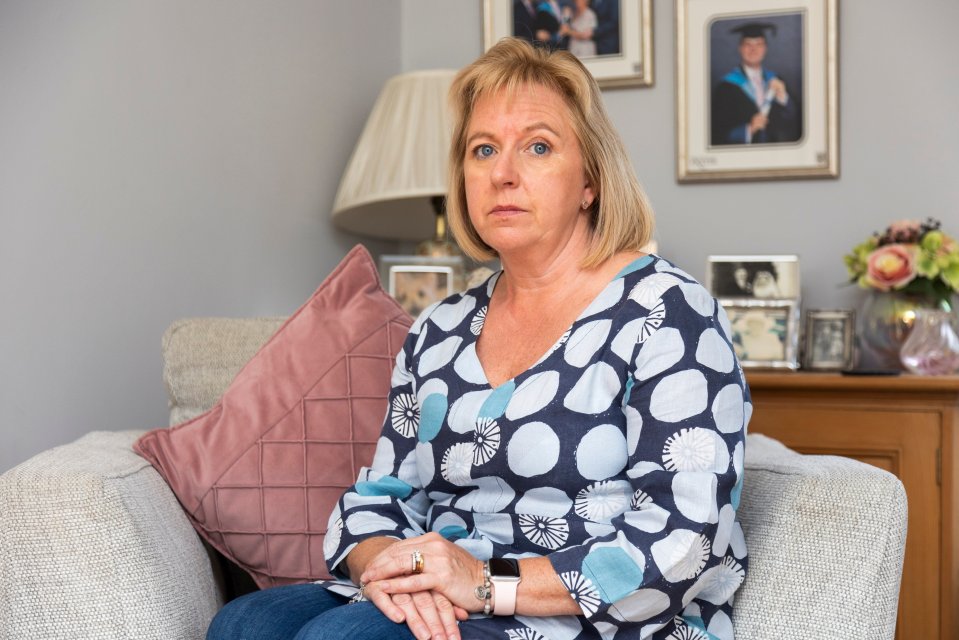 a woman in a blue and white polka dot shirt sits on a couch