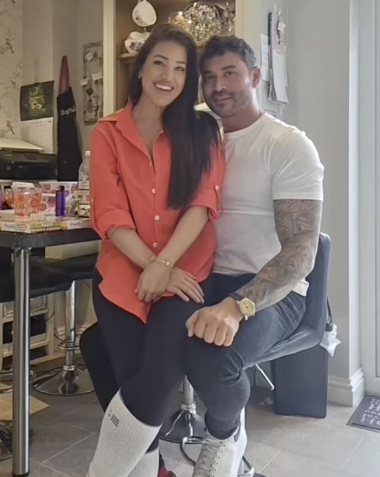 a man and a woman are posing for a picture and the man is wearing a watch