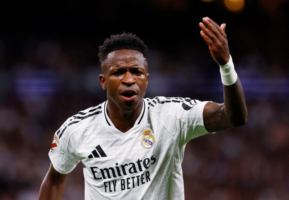 a soccer player wearing a white emirates fly better jersey