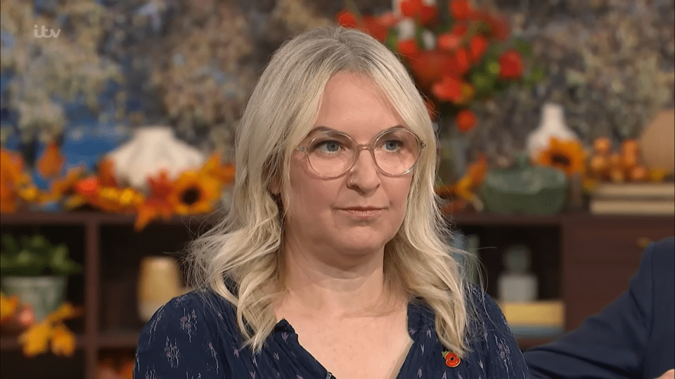 a woman wearing glasses and a blue shirt is on a tv show