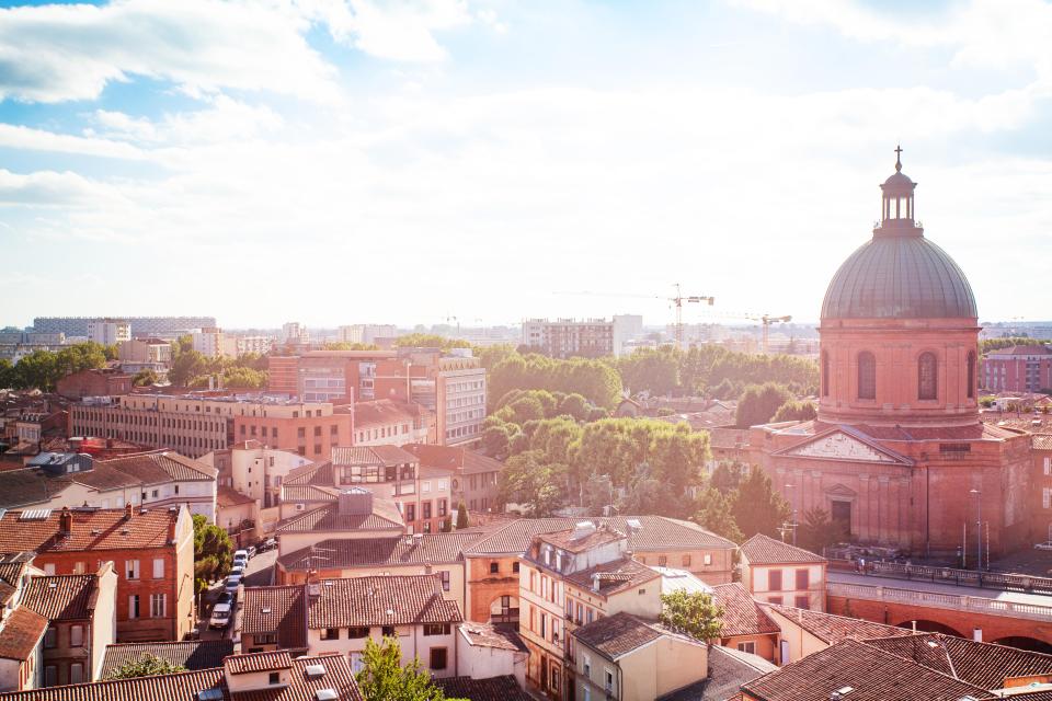 an aerial view of a city with a dome in the middle