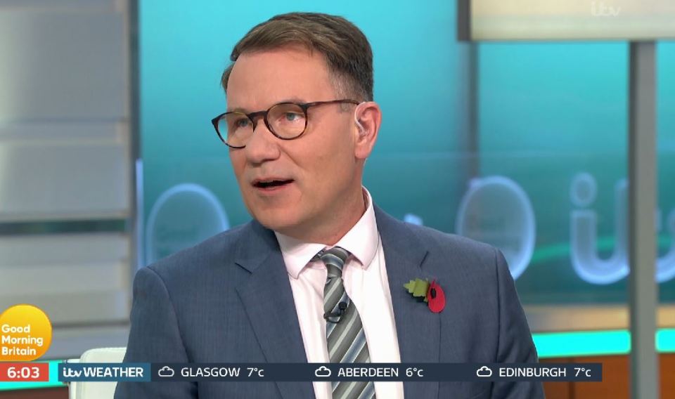 a man in a suit and tie is on a good morning britain show