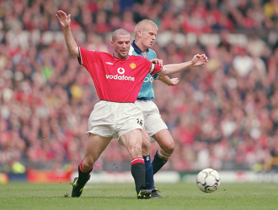 a man in a red vodafone jersey is playing soccer