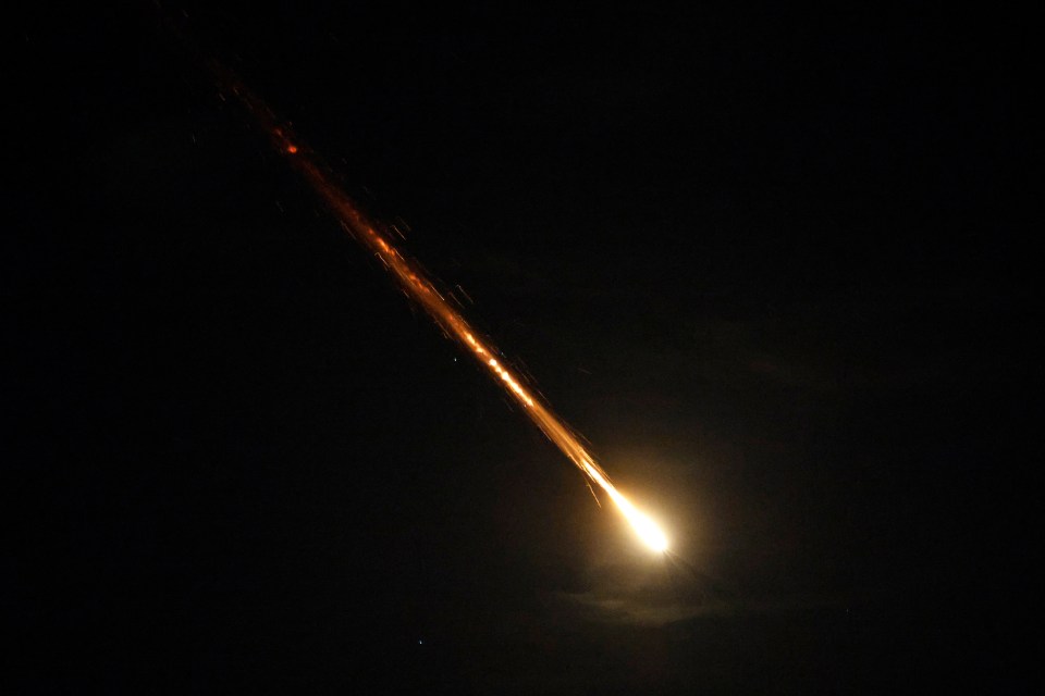 a bright light is shining in the dark sky