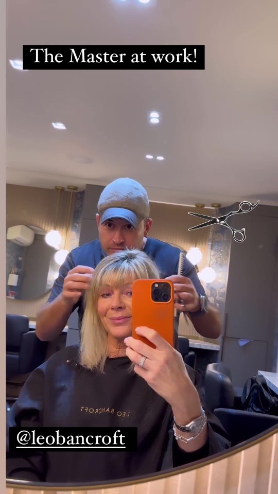 a woman taking a picture of herself in a mirror with the caption the master at work