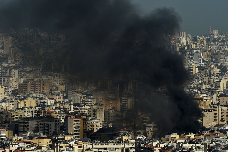 smoke coming out of a building in a city