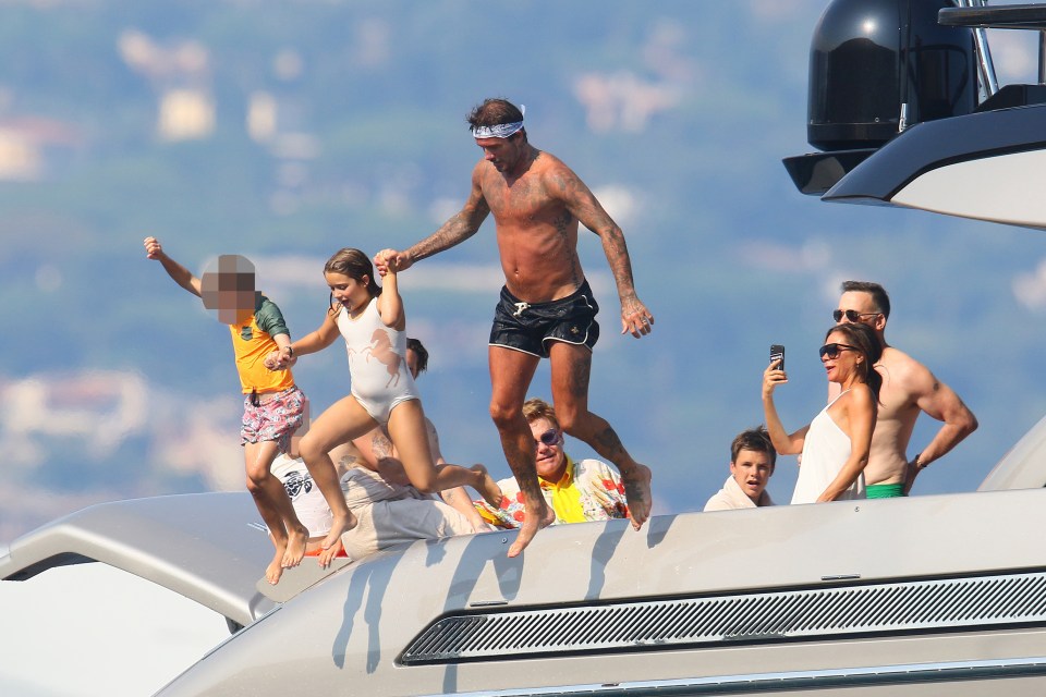 a group of people on a boat one of whom is wearing a yellow shirt that says ' sydney ' on it