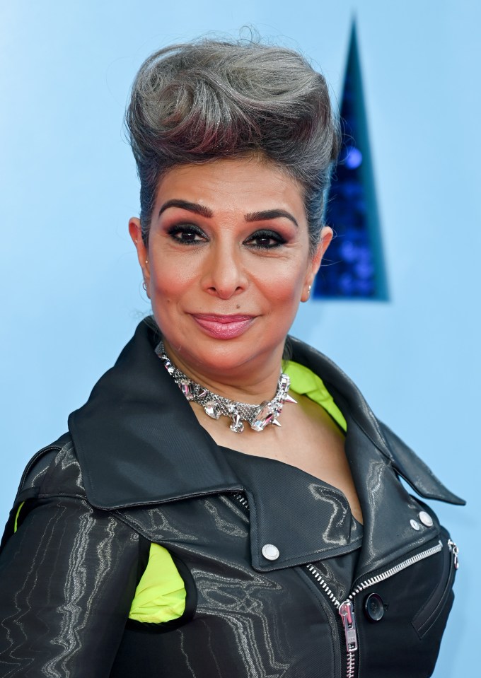 a woman with gray hair wearing a black leather jacket