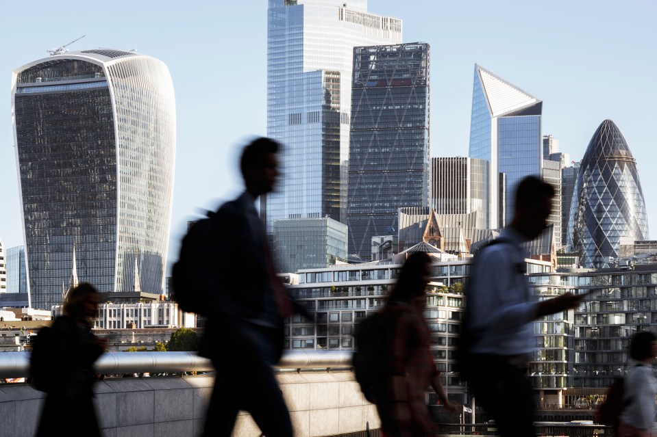 UK, London, blurred motion of incidental business people walking to work with view of the financial district behind