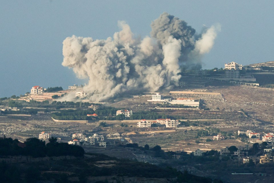 a large cloud of smoke is coming out of a building