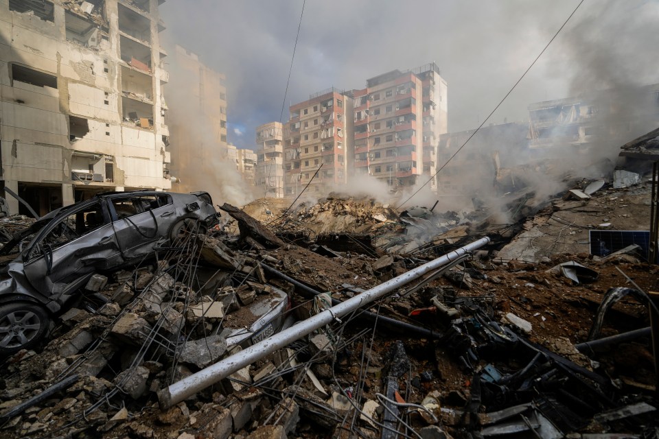 a car is sitting in the middle of a pile of rubble