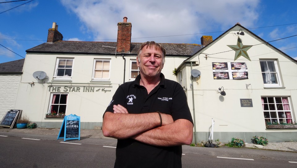 a man stands in front of the star inn