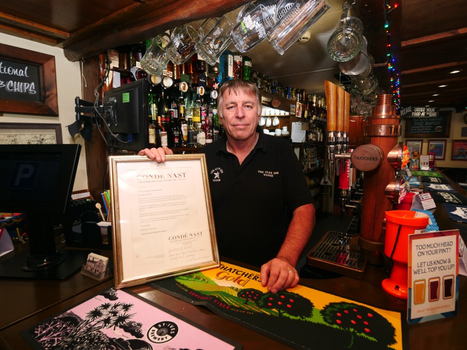 a man holding a certificate that says conde nast
