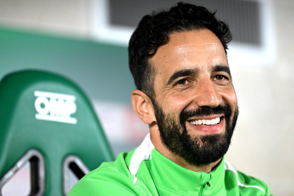 a man with a beard is smiling in front of a omp seat