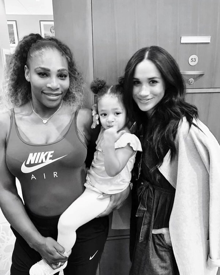 a woman wearing a nike air tank top holds a little girl