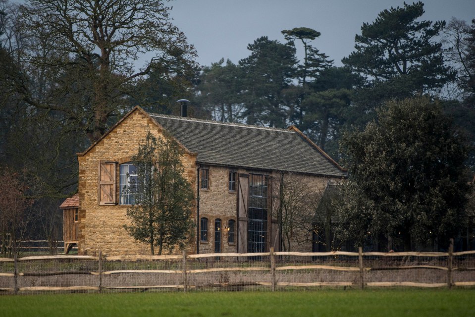 a brick building with a fence in front of it