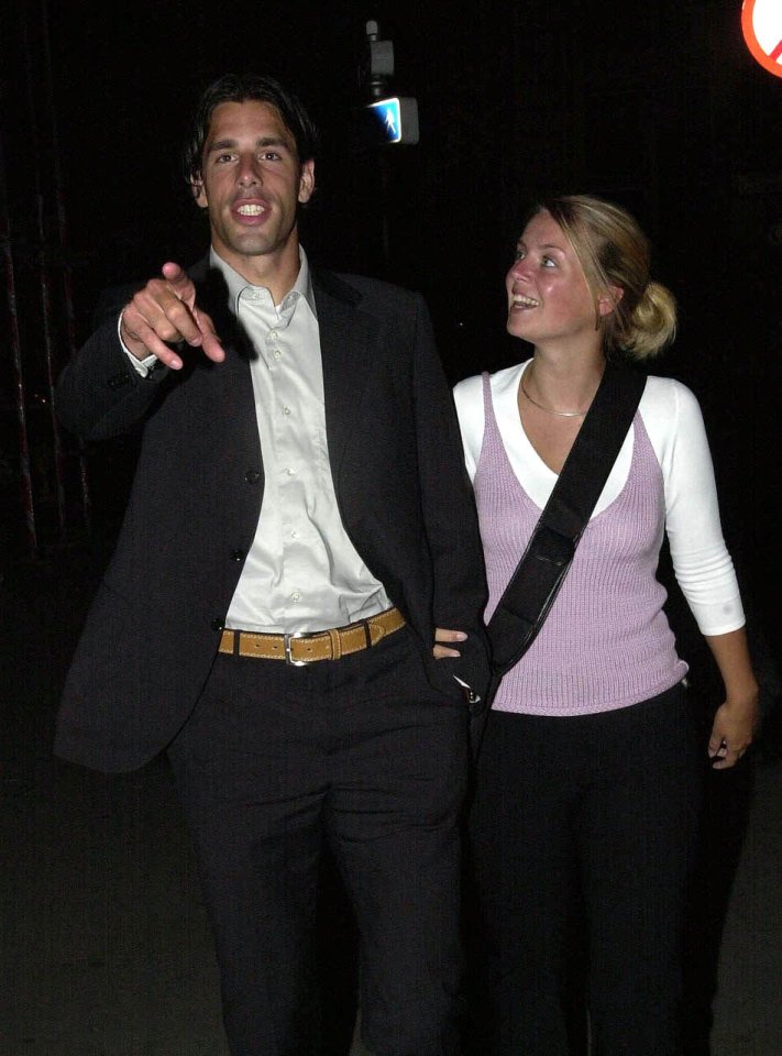 a man in a suit and a woman in a purple top are standing next to each other