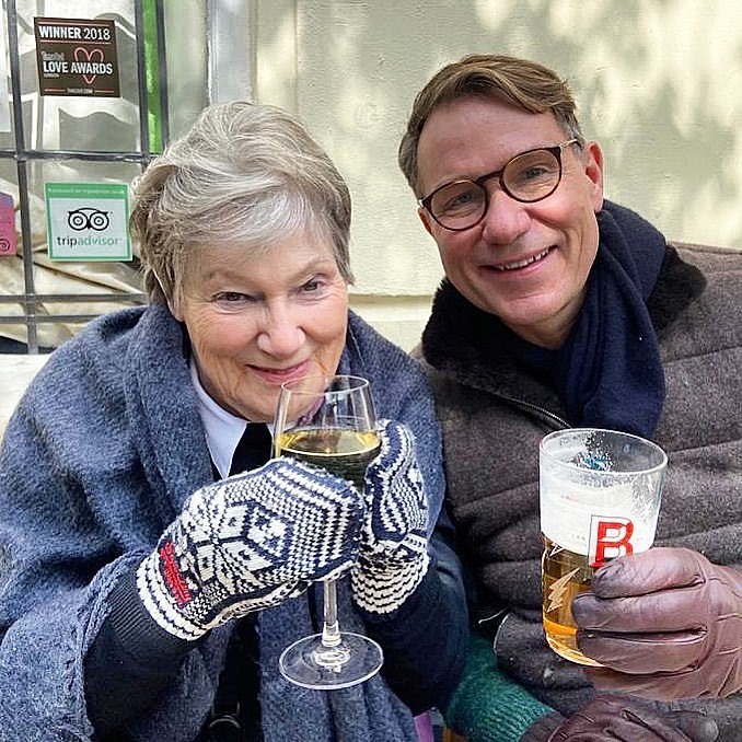 a man and a woman are toasting with wine glasses and a sign that says love awards