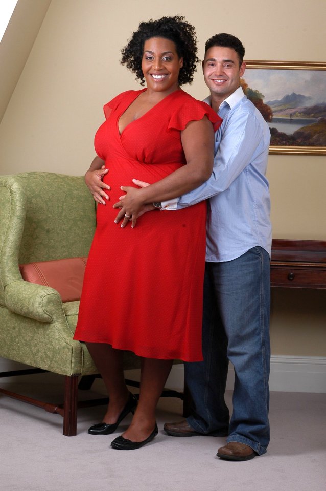 a woman in a red dress stands next to a man in a blue shirt