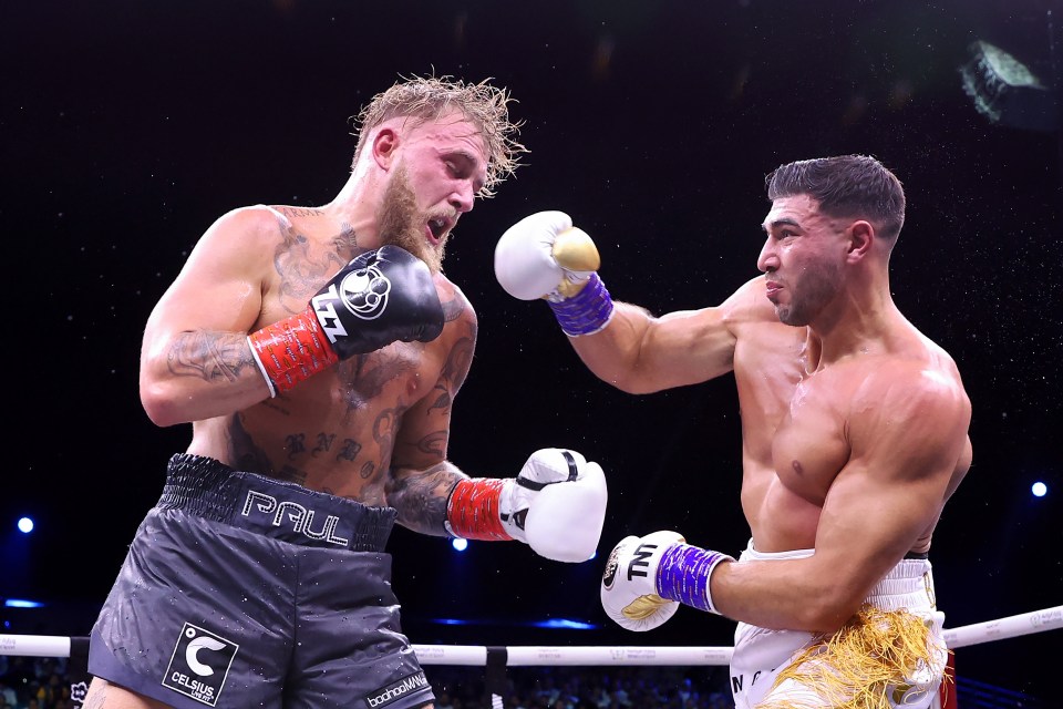 two boxers in a ring with one wearing paul shorts