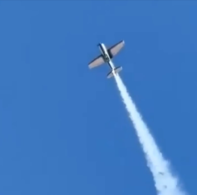 a small plane is flying through a clear blue sky
