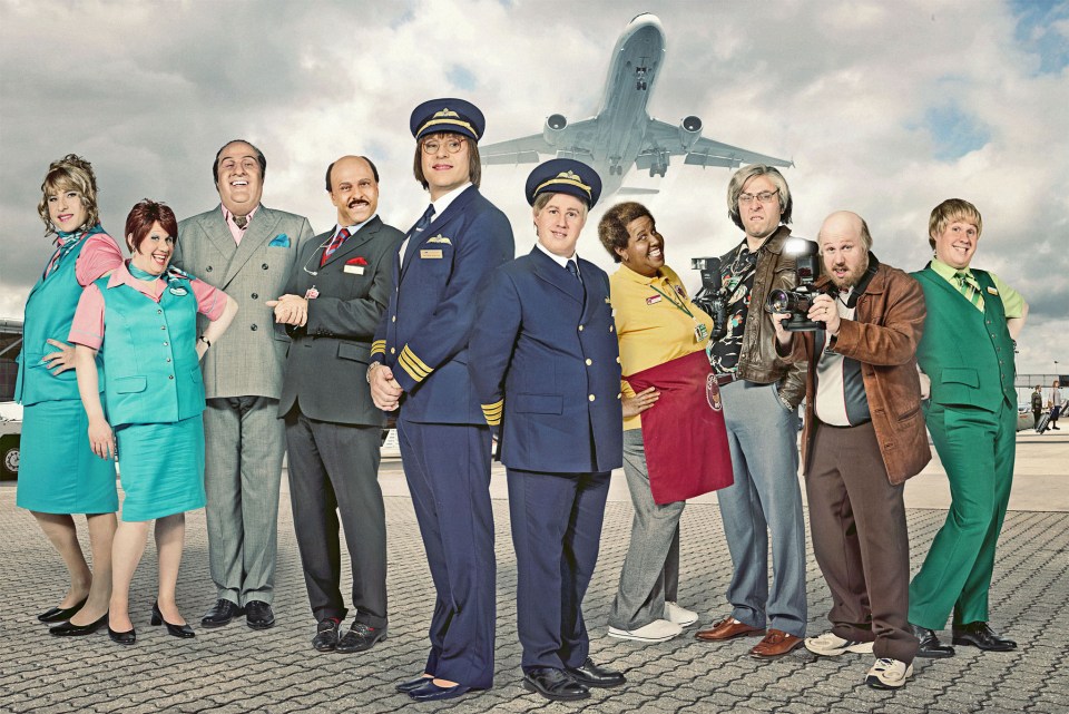 a group of people posing for a picture with an airplane in the background