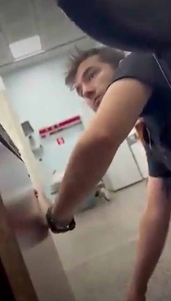 a man is standing next to a door in a room .
