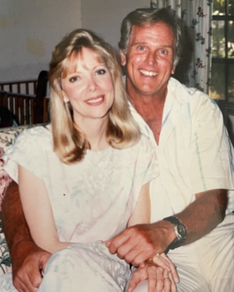 a man and woman are posing for a picture and the woman is wearing a watch
