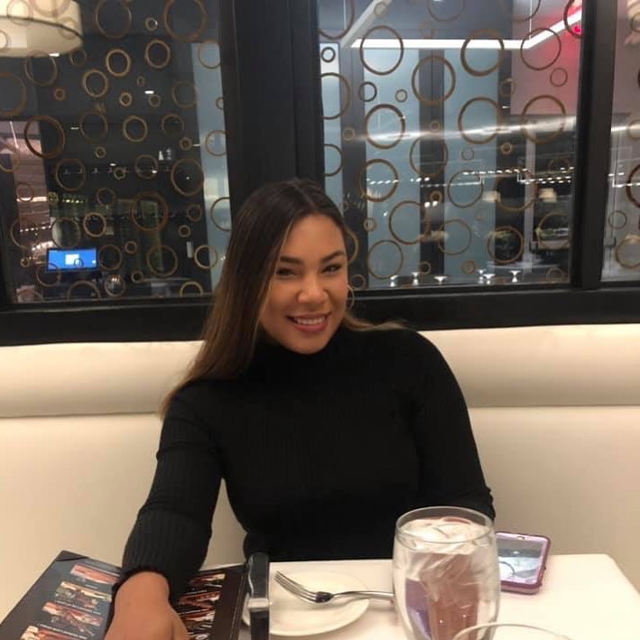 a woman sits at a table with a menu on it