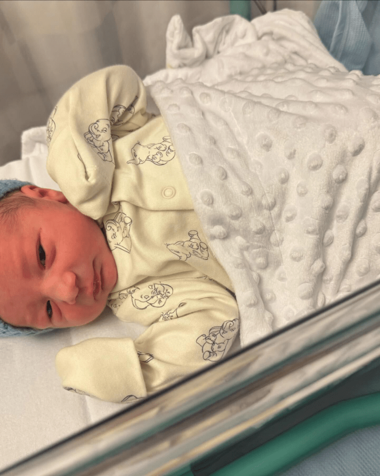 a newborn baby is laying on a white blanket