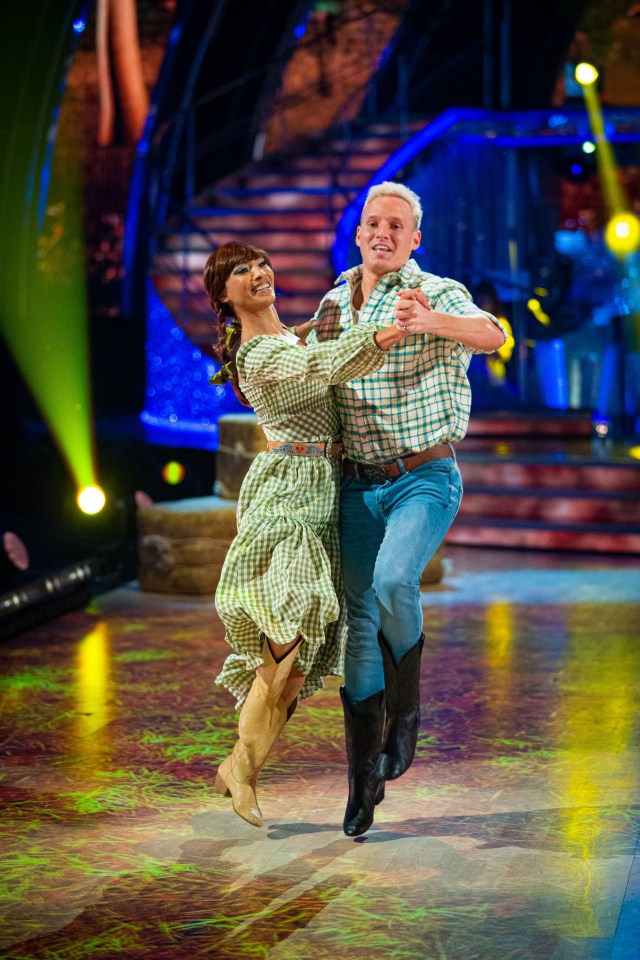 a man and a woman are dancing on a stage