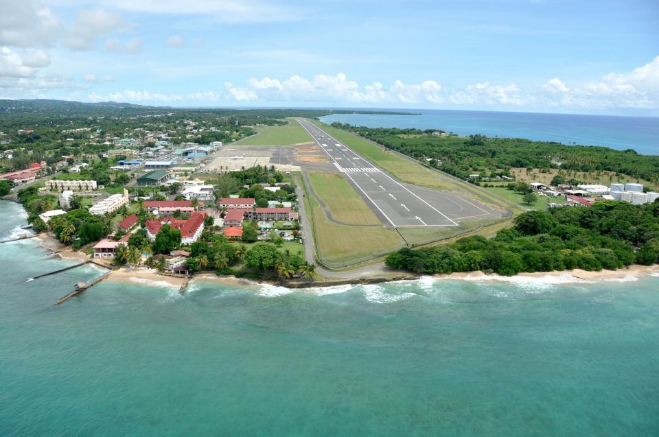 an aerial view of a small island with a runway