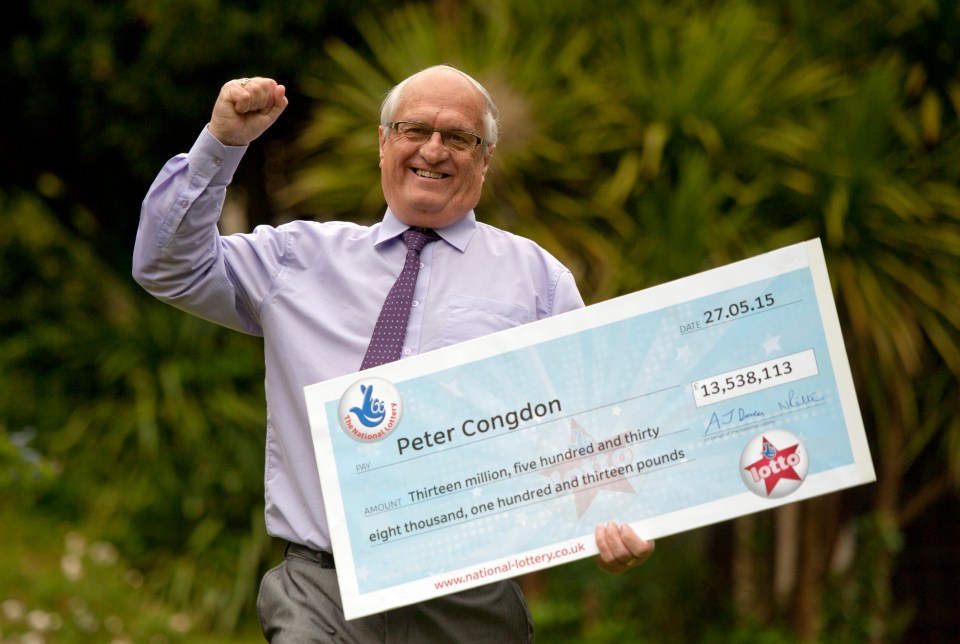 a man holding a cheque that says peter congdon on it