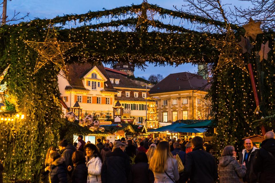 a crowd of people are gathered at a christmas market