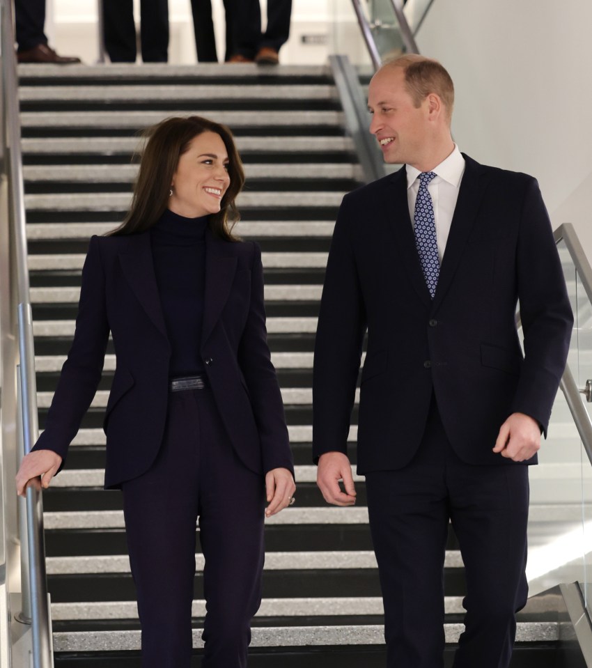 a man and a woman are walking down a set of stairs