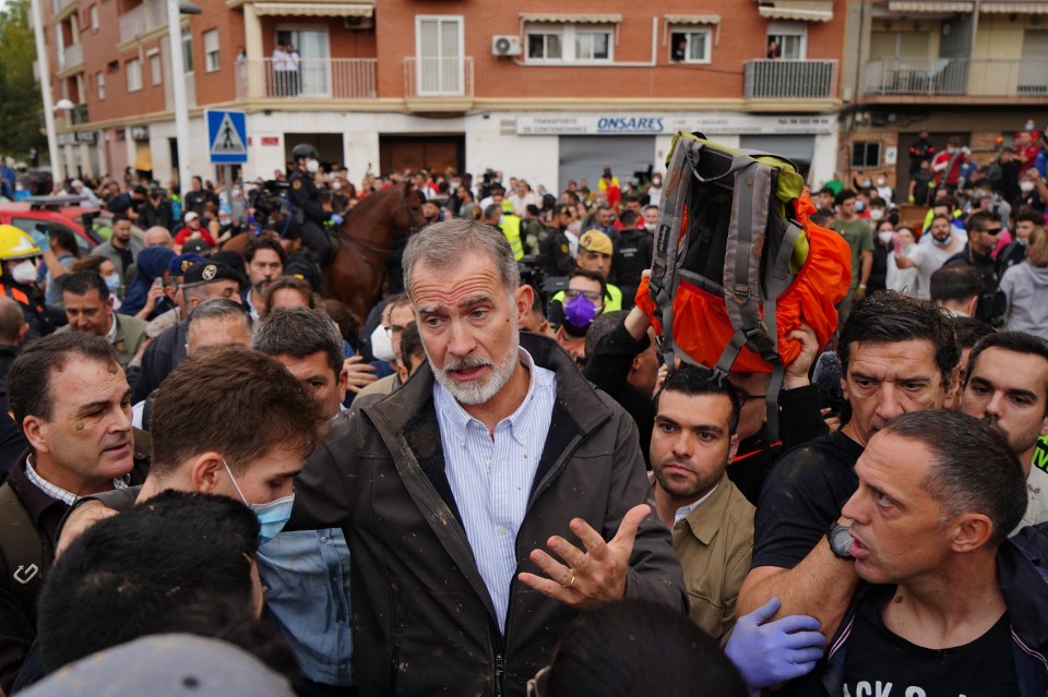 a crowd of people are gathered in front of a store called omsares