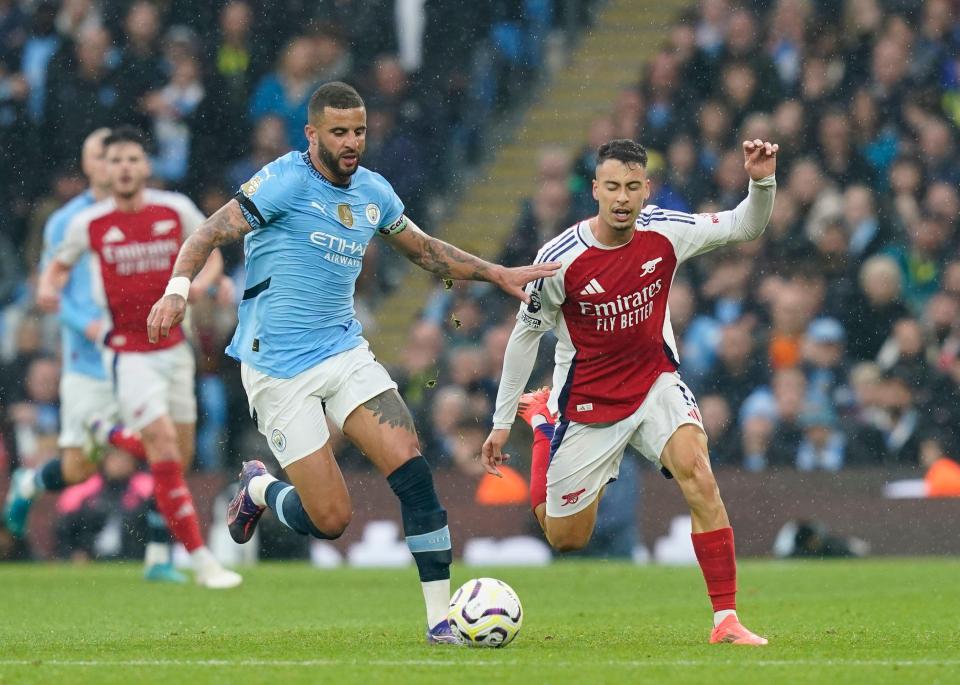 two soccer players are playing a game and one of them is wearing a jersey that says emirates fly better