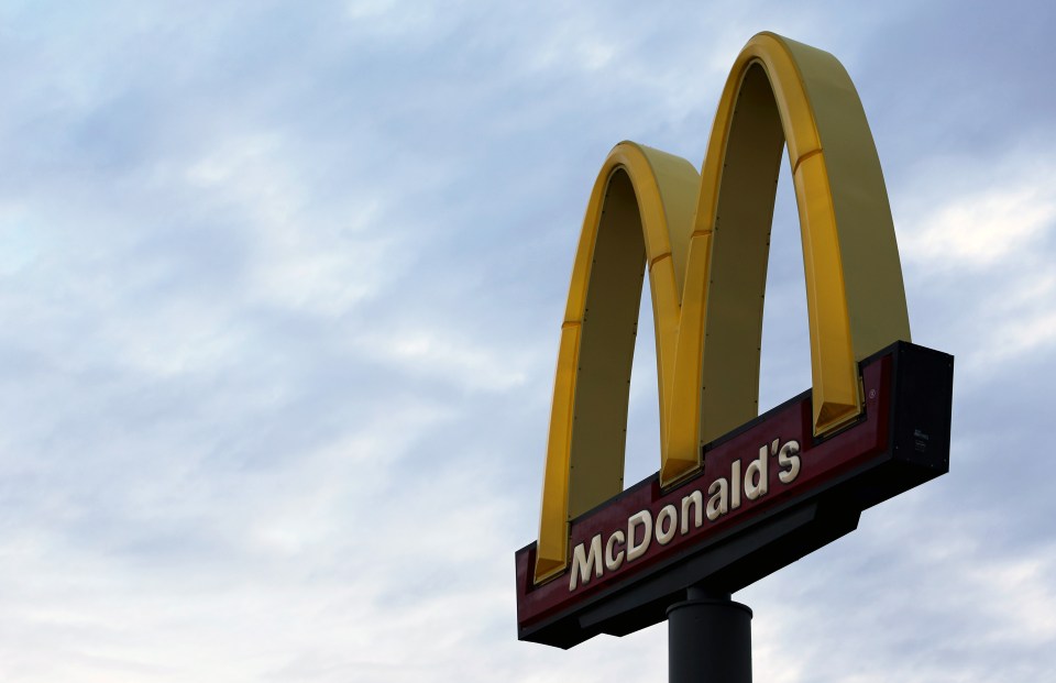 a mcdonald 's sign against a cloudy sky