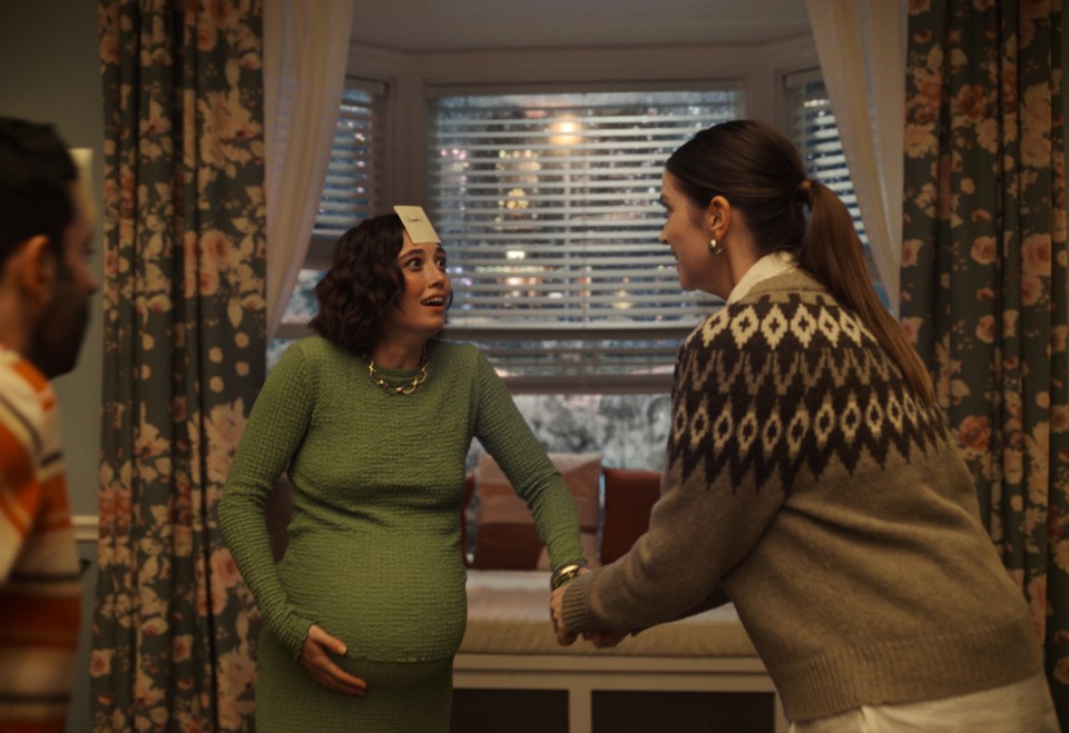 a pregnant woman with a name tag on her head